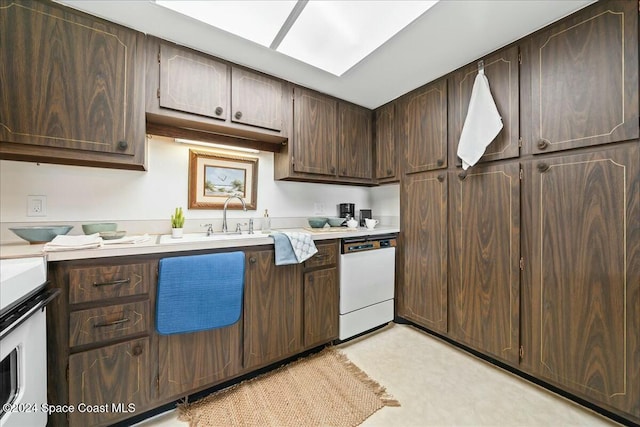 kitchen featuring dark brown cabinetry, white dishwasher, and sink