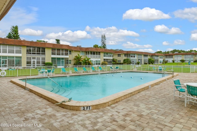 view of swimming pool with a patio area