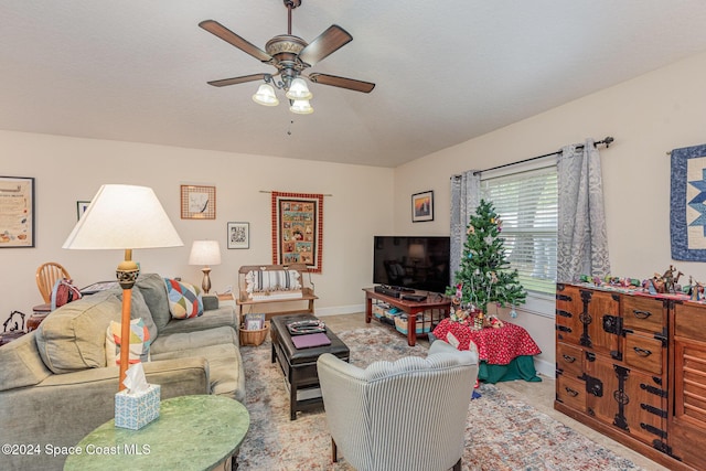 carpeted living room with ceiling fan