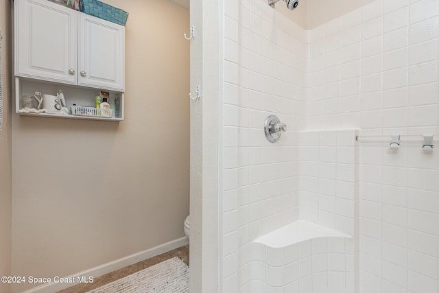 bathroom featuring toilet and walk in shower