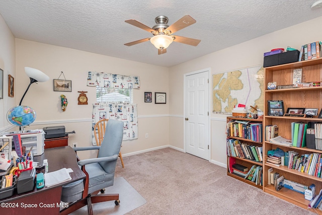 carpeted home office featuring ceiling fan and a textured ceiling