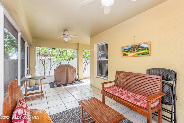 sunroom / solarium featuring ceiling fan