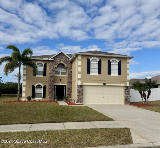 view of front of house featuring a garage and a front yard