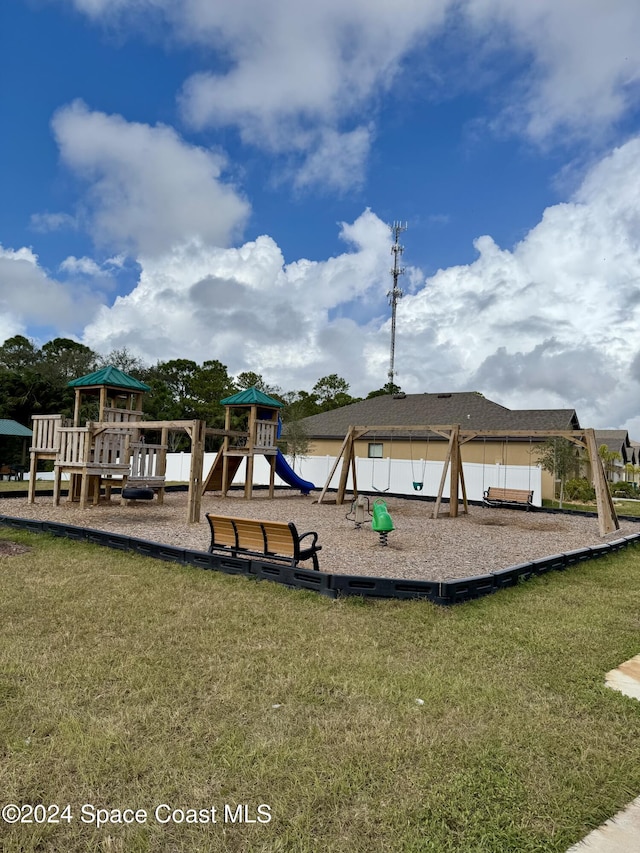 view of jungle gym featuring a lawn