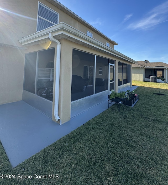 view of home's exterior featuring a yard and a sunroom