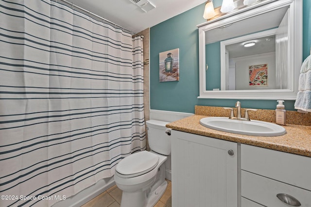 bathroom with tile patterned floors, vanity, and toilet