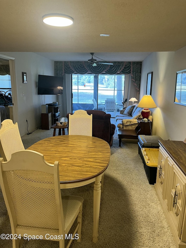 dining area with carpet flooring and ceiling fan