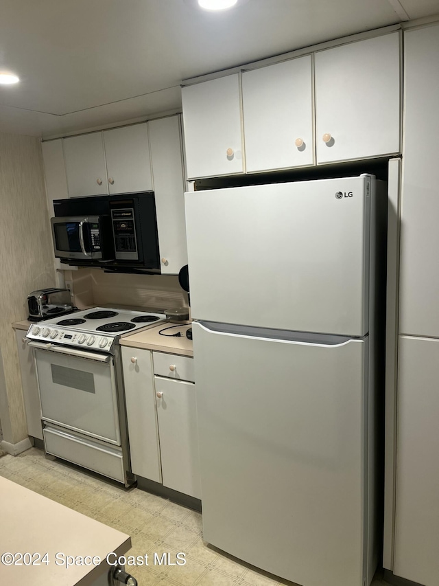 kitchen with white cabinets and white appliances