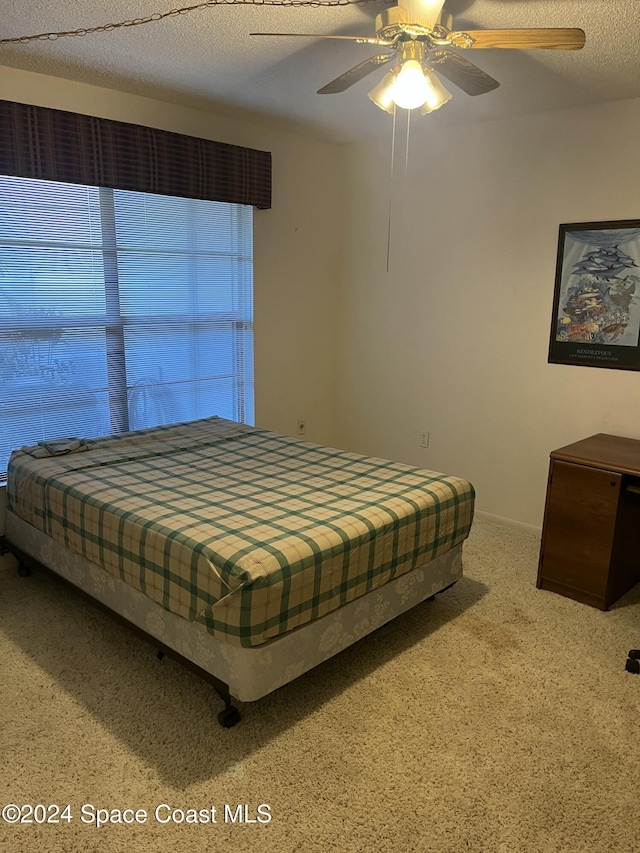 bedroom featuring a textured ceiling and ceiling fan