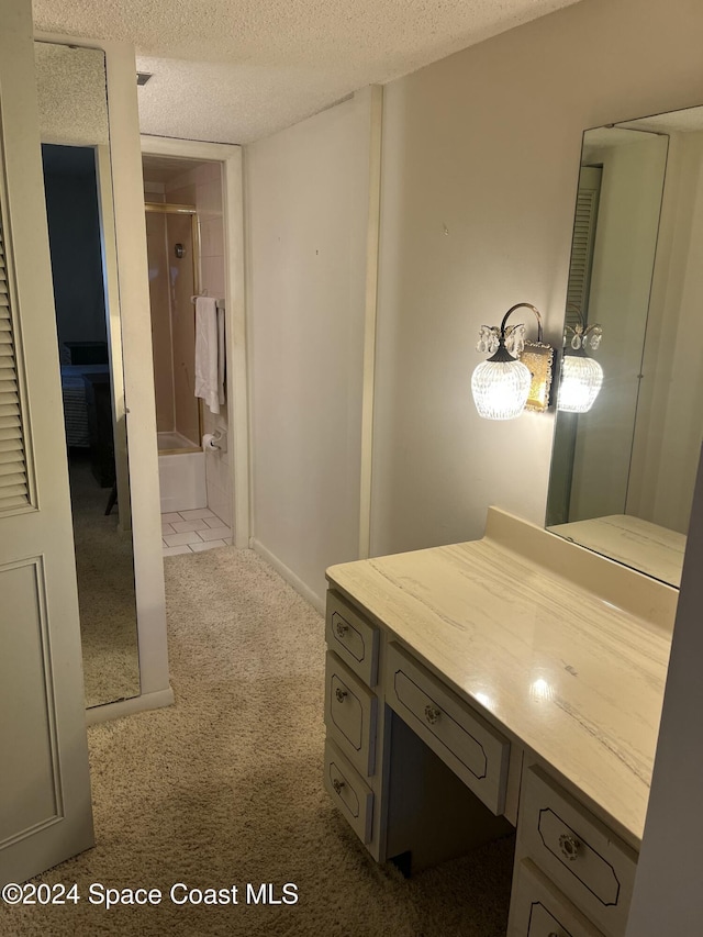 bathroom with vanity, a textured ceiling, and walk in shower