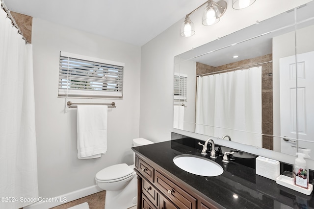 bathroom featuring tile patterned flooring, vanity, curtained shower, and toilet