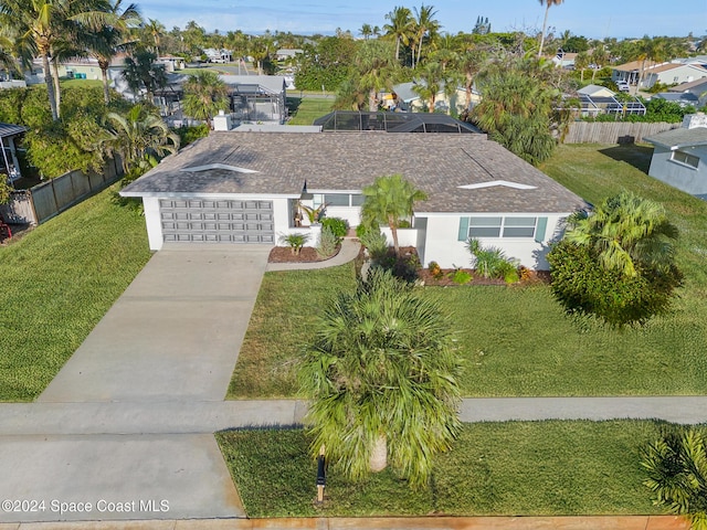 view of front of home with a garage and a front lawn