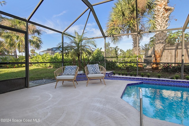 view of swimming pool featuring a patio and a lanai