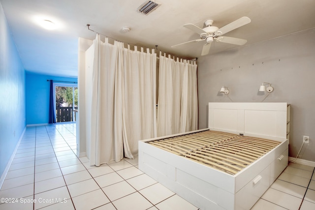 unfurnished bedroom with light tile patterned floors and ceiling fan