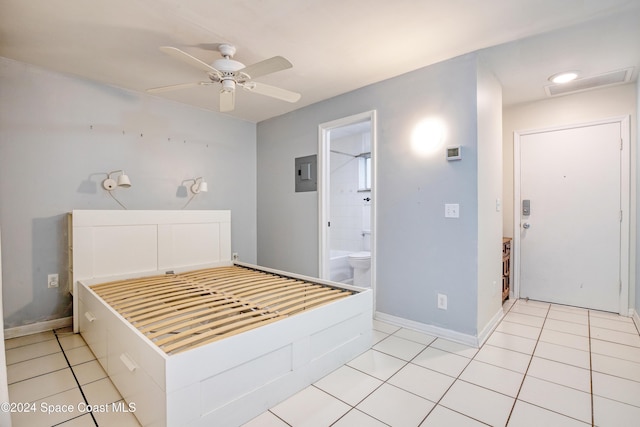 tiled bedroom with ceiling fan, ensuite bathroom, and electric panel