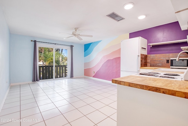 unfurnished living room with light tile patterned floors and ceiling fan