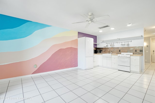 kitchen with light tile patterned floors, white appliances, ceiling fan, white cabinets, and decorative backsplash