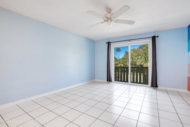 tiled spare room with ceiling fan