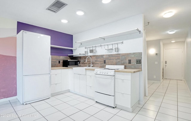 kitchen with white cabinetry, white appliances, and backsplash