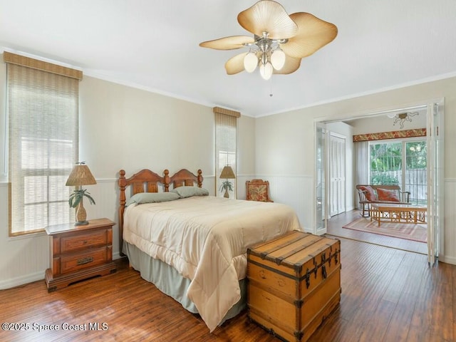 bedroom featuring hardwood / wood-style flooring, ceiling fan, and ornamental molding