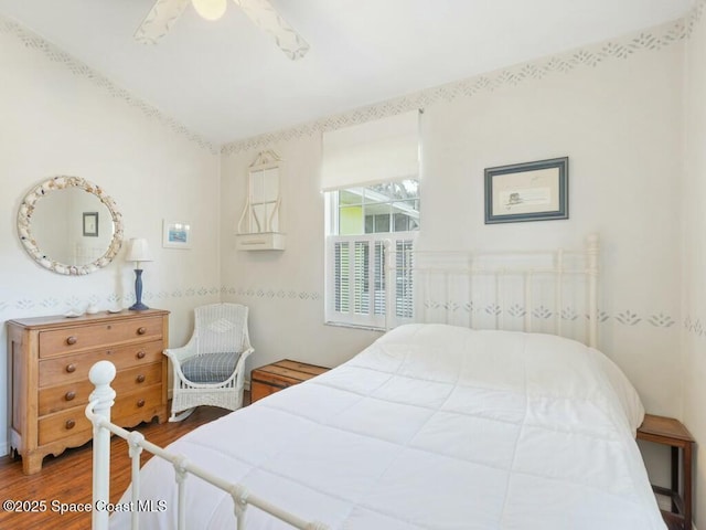 bedroom with ceiling fan and hardwood / wood-style floors