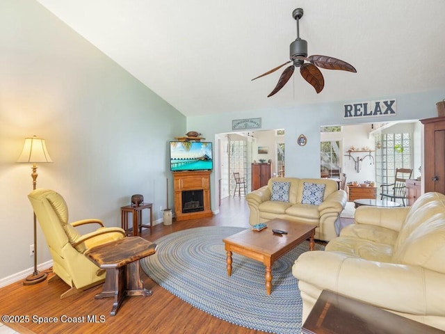 living room with hardwood / wood-style floors, ceiling fan, and lofted ceiling