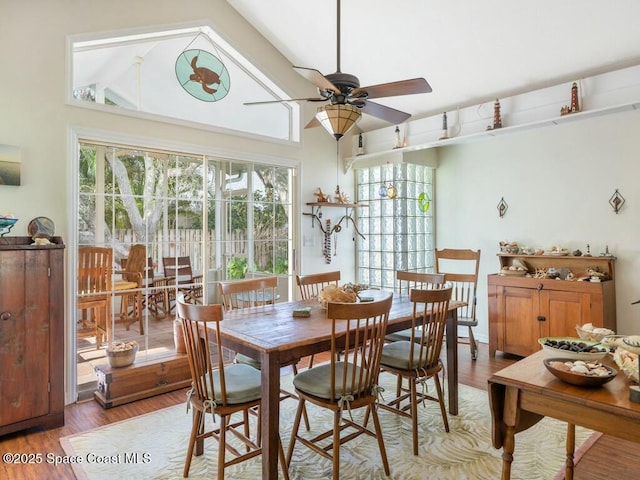 dining area with hardwood / wood-style flooring, ceiling fan, and lofted ceiling