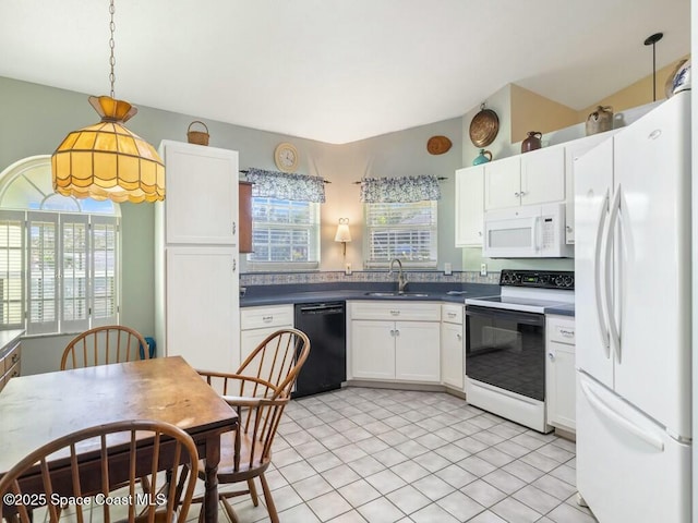 kitchen with white appliances, sink, decorative light fixtures, white cabinetry, and plenty of natural light