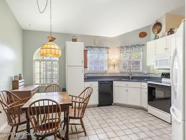 kitchen with white appliances, sink, decorative light fixtures, white cabinets, and light tile patterned flooring