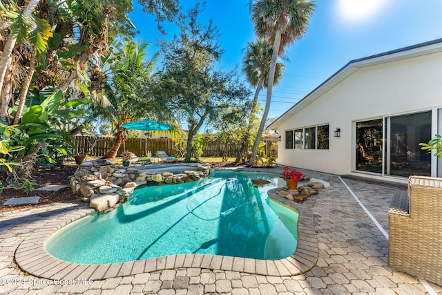 view of pool featuring an in ground hot tub and a patio