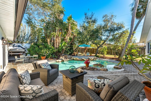 view of patio featuring an outdoor living space and a fenced in pool