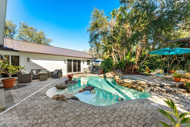 401 S Palm Ave, Indialantic, FL 32903 - view of swimming pool with a patio, outdoor lounge area, and a pool with connected hot tub