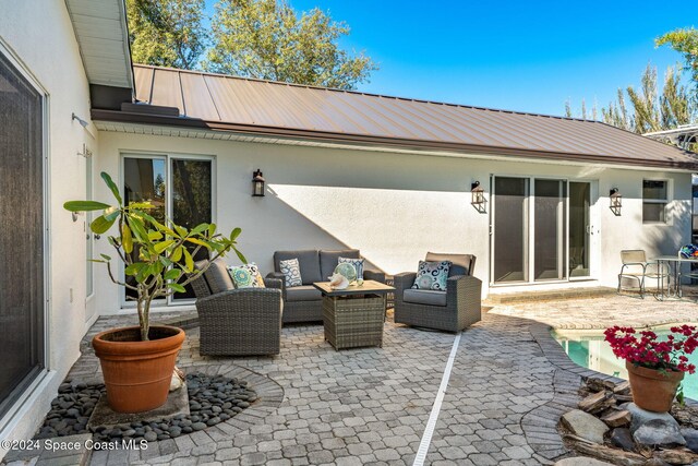 401 S Palm Ave, Indialantic, FL 32903 - view of patio / terrace with an outdoor living space and an outdoor pool