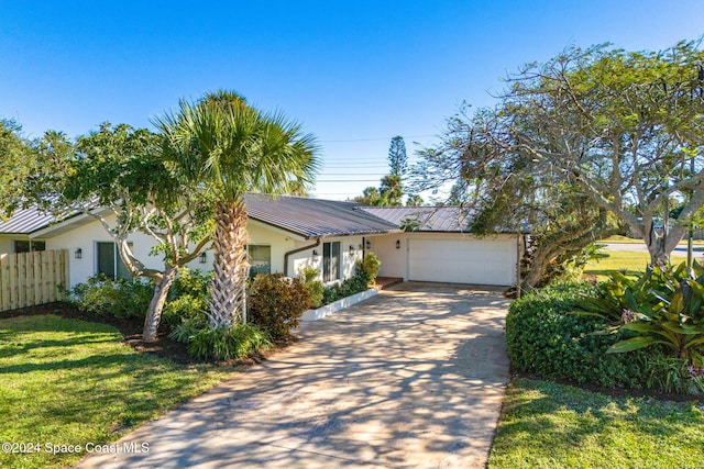 view of front of home featuring a garage and a front lawn