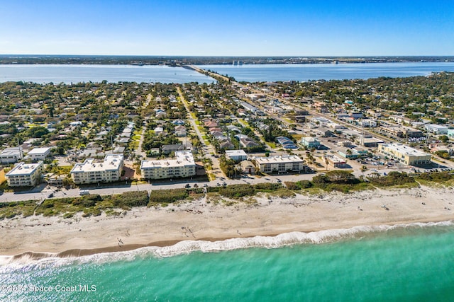 bird's eye view featuring a water view and a beach view