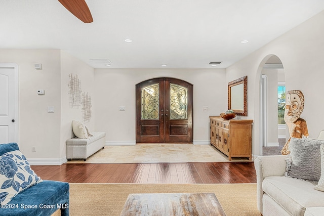 foyer entrance with wood-type flooring and french doors