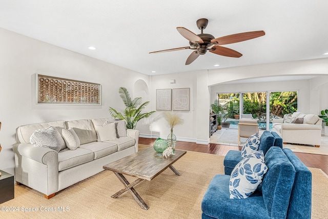 living room featuring hardwood / wood-style flooring and ceiling fan