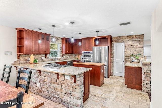 kitchen featuring pendant lighting, a kitchen breakfast bar, decorative backsplash, appliances with stainless steel finishes, and kitchen peninsula