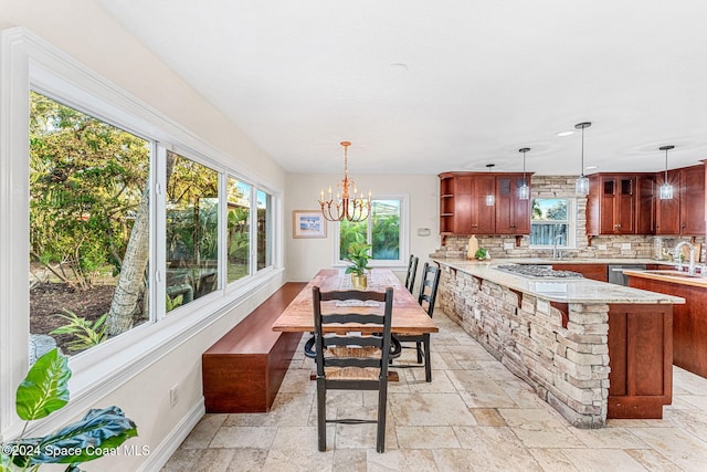 dining room featuring sink and a chandelier