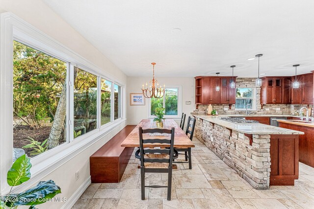401 S Palm Ave, Indialantic, FL 32903 - dining room with stone tile flooring and a chandelier