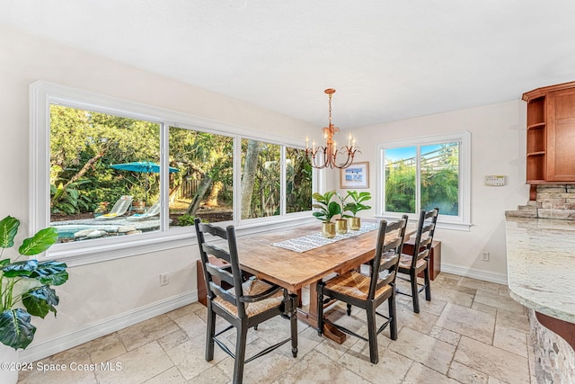 dining space with a chandelier