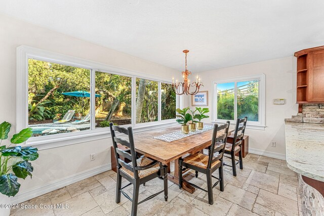 401 S Palm Ave, Indialantic, FL 32903 - dining room with stone tile floors and a chandelier