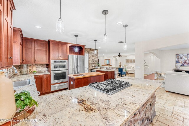 401 S Palm Ave, Indialantic, FL 32903 - kitchen featuring open floor plan, appliances with stainless steel finishes, a warming drawer, arched walkways, and a center island
