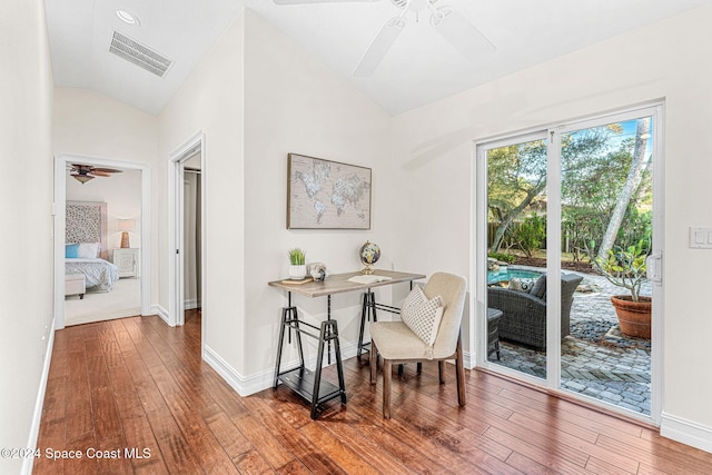 interior space with ceiling fan, vaulted ceiling, and hardwood / wood-style flooring