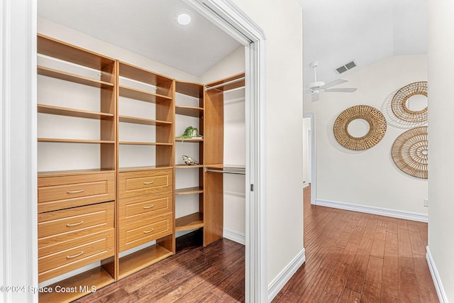 walk in closet featuring ceiling fan, dark hardwood / wood-style flooring, and lofted ceiling