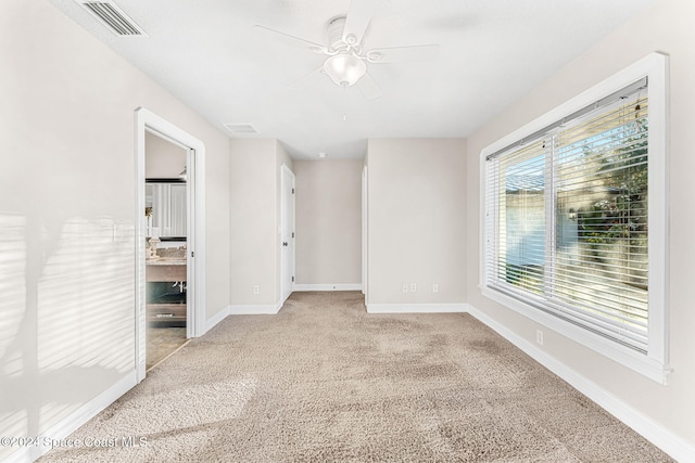 spare room with light carpet and ceiling fan