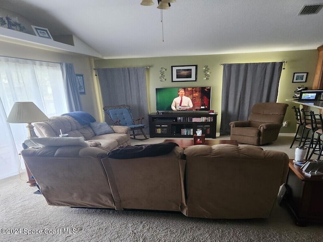 living room with carpet, ceiling fan, and vaulted ceiling