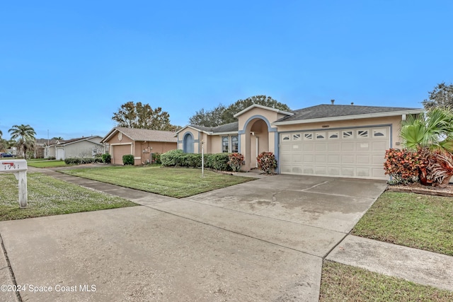 ranch-style house featuring a garage and a front lawn