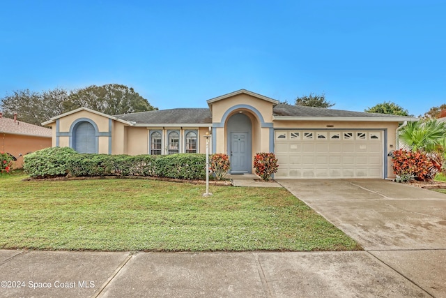 view of front of home featuring a front lawn and a garage