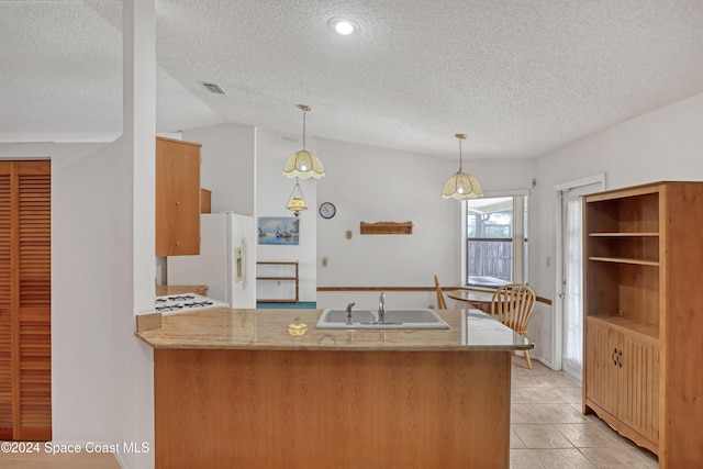 kitchen featuring kitchen peninsula, sink, light tile patterned floors, and vaulted ceiling